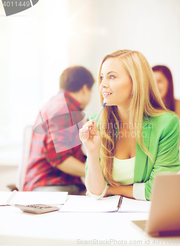 Image of student girl with notebook and calculator