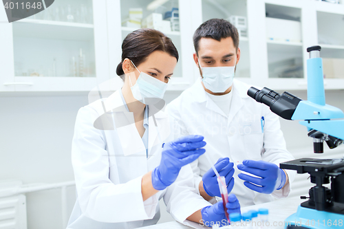 Image of young scientists making test or research in lab