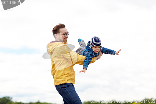 Image of father with son playing and having fun outdoors