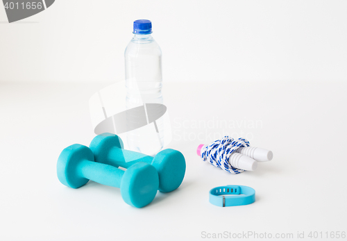 Image of dumbbells, skipping rope, pulse tracker and bottle