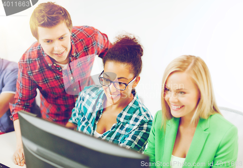 Image of students with computer studying at school