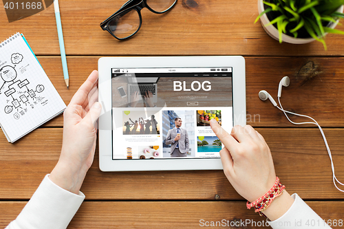 Image of close up of woman hands with tablet pc on table