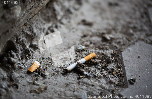 Image of close up of smoked cigarette butt on ground