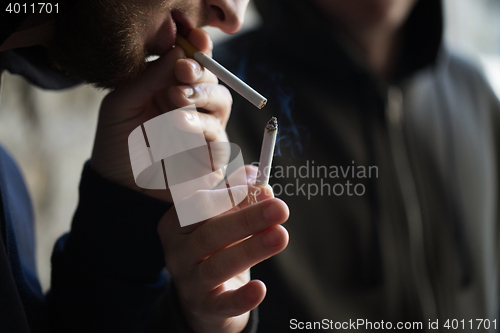 Image of close up of young people smoking cigarette