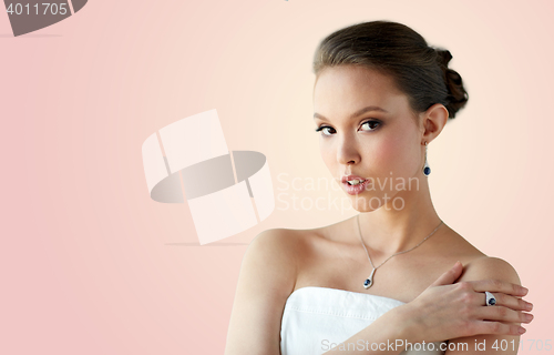 Image of beautiful woman with earring, ring and pendant