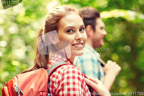 Image of group of smiling friends with backpacks hiking