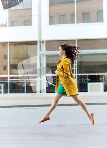 Image of happy young woman or teenage girl on city street