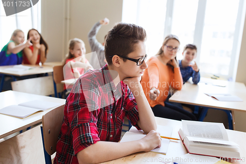 Image of classmates laughing at student boy in school