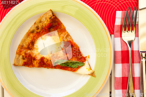 Image of margarita pizza with basil on a plate