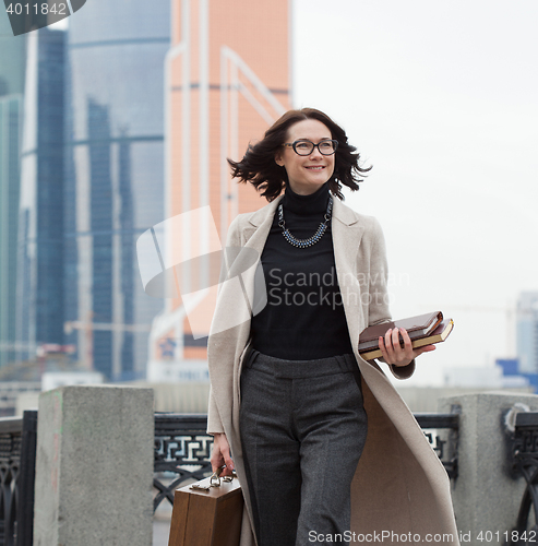 Image of smiling middle aged brunette in the business district of the cit