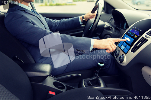 Image of close up of man driving car with board computer