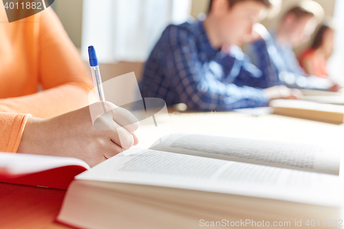 Image of close up of students with book writing school test