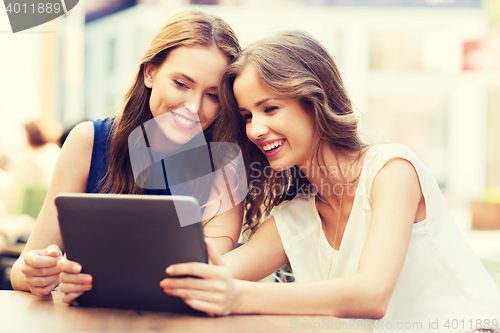 Image of happy young women or teenage girls with tablet pc