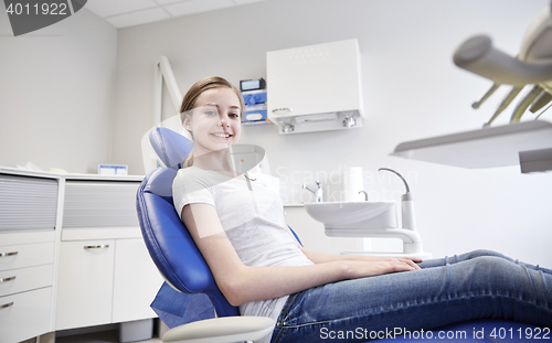 Image of happy patient girl at dental clinic office