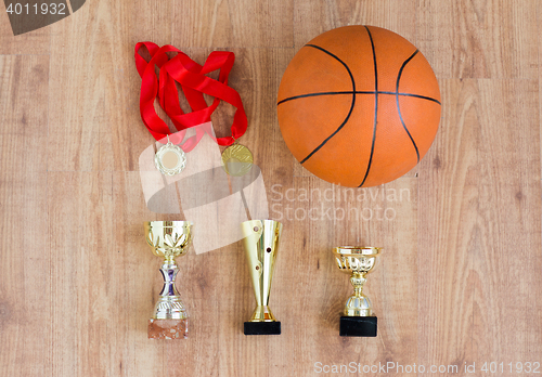 Image of basketball ball with cups and golden medals