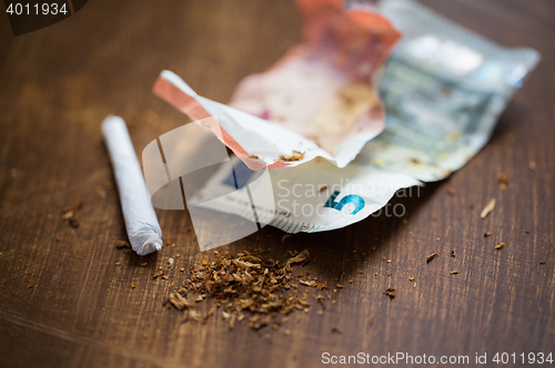 Image of close up of marijuana joint and money