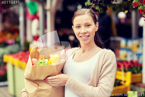 Image of woman with bag of food at street market