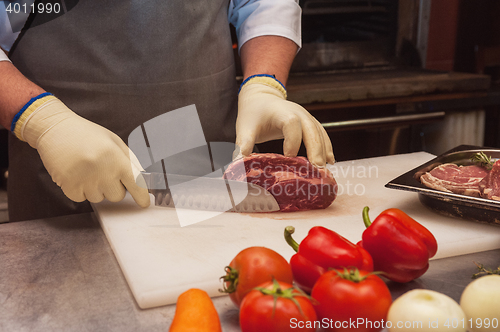 Image of Chef cutting meat