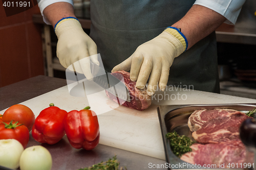 Image of Chef cutting meat