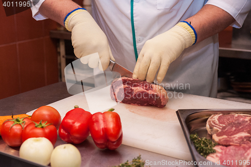 Image of Chef cutting meat