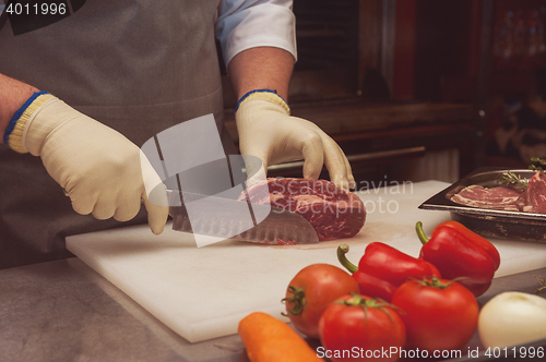 Image of Chef cutting meat