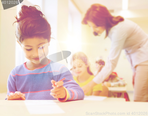 Image of happy little school girl over classroom background