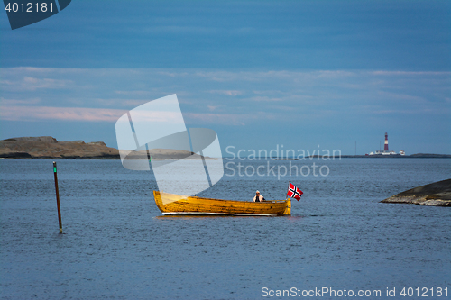 Image of Seascape - Ferder lighthouse and wooden boat