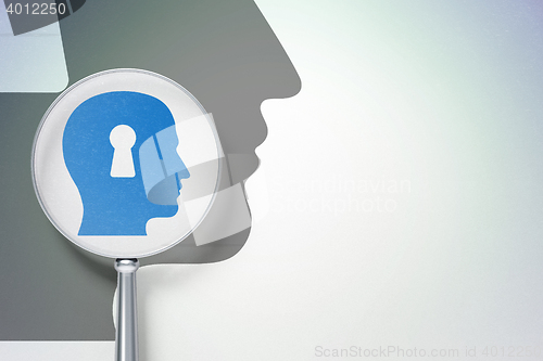 Image of Business concept:  Head With Keyhole with optical glass on digital background