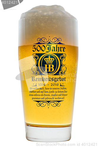 Image of Glass cold Bavarian beer with frothy foam head backlit isolated