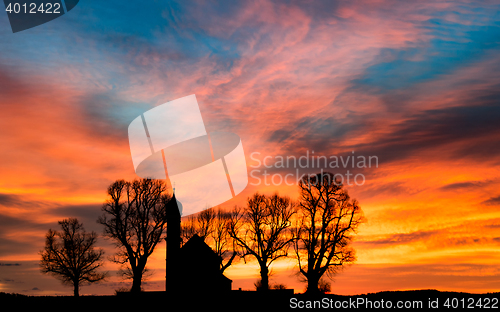 Image of Early morning sunrise dawn with silhouette small church or chapel