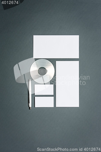 Image of Mock-up business template with cards, papers, disk. Gray background.