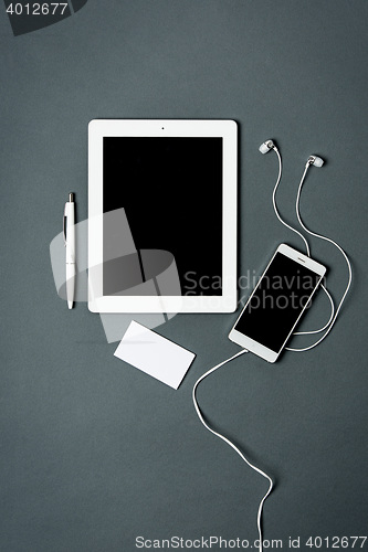 Image of Mock-up business template with phone, tablet. Gray background.