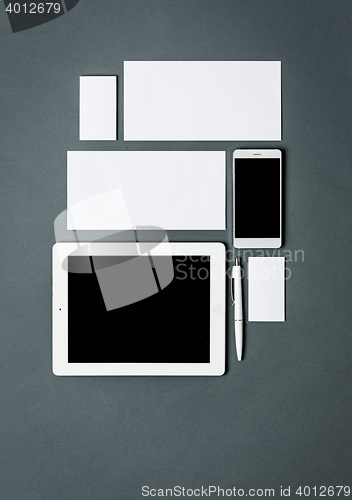 Image of Mock-up business template with cards, papers, tablet. Gray background.