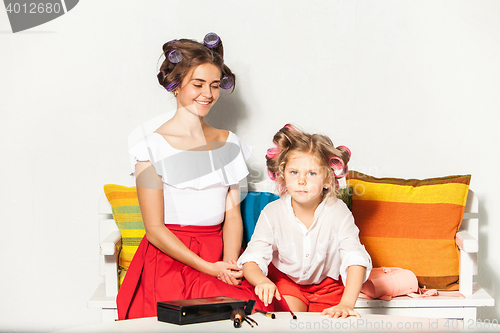 Image of Little girl playing with her mom\'s makeup