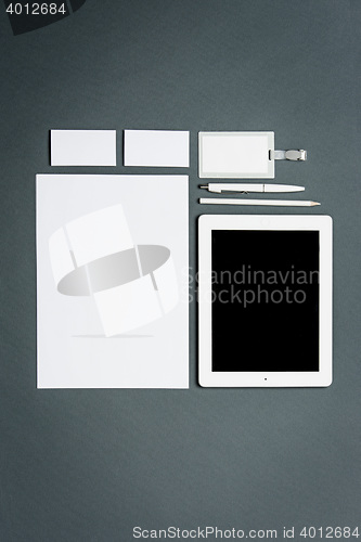 Image of Mock-up business template with cards, papers, tablet. Gray background.