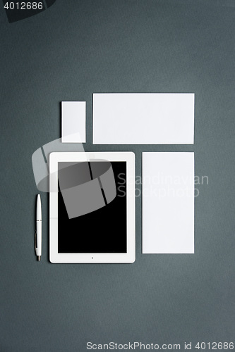 Image of Mock-up business template with cards, papers, tablet. Gray background.