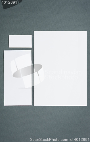 Image of Mock-up business template with cards, papers, pen. Gray background.