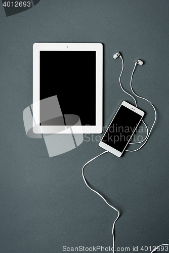 Image of Mock-up business template with phone, tablet. Gray background.