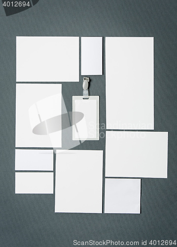 Image of Mock-up business template with cards, papers, pen. Gray background.