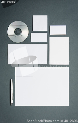 Image of Mock-up business template with cards, papers, disk. Gray background.