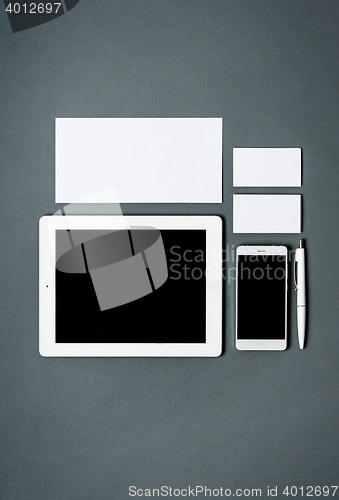 Image of Mock-up business template with cards, papers, tablet. Gray background.