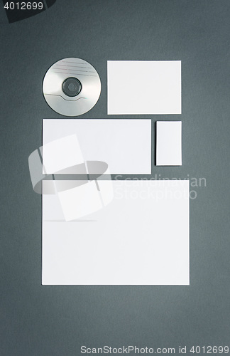 Image of Mock-up business template with cards, papers, disk. Gray background.