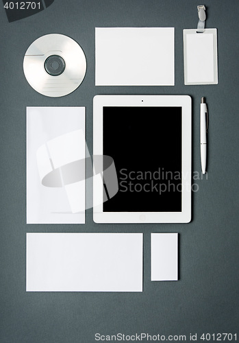 Image of Mock-up business template with cards, papers, tablet. Gray background.