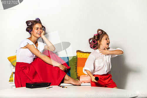 Image of Little girl playing with her mom\'s makeup