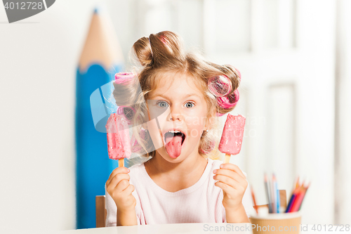 Image of Little girl sitting and eating ice cream
