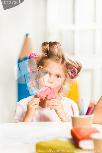Image of Little girl sitting and eating ice cream