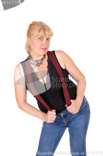 Image of Pretty woman standing with suspenders.