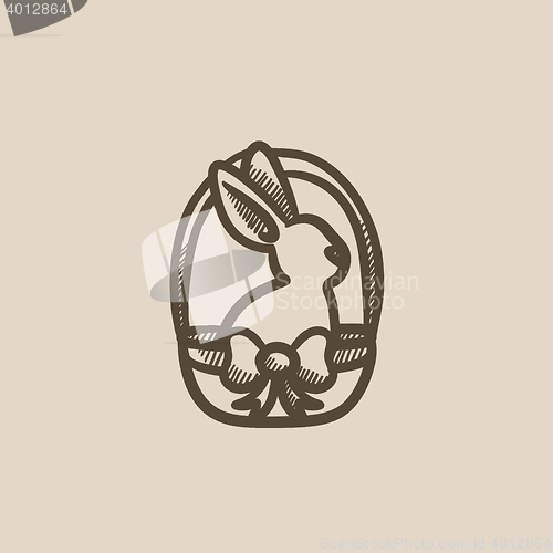 Image of Easter bunny sitting in basket sketch icon.