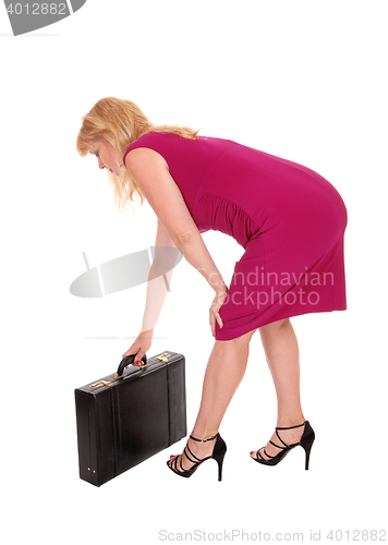 Image of Woman bending getting brief case.