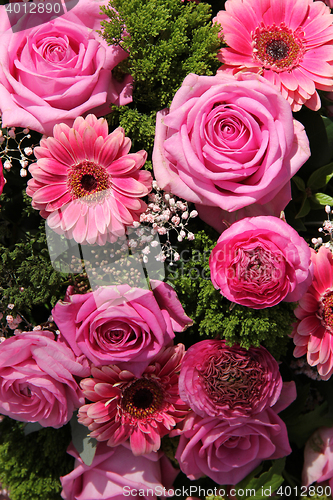 Image of Ranunculus, roses and gerberas in a wedding arrangement